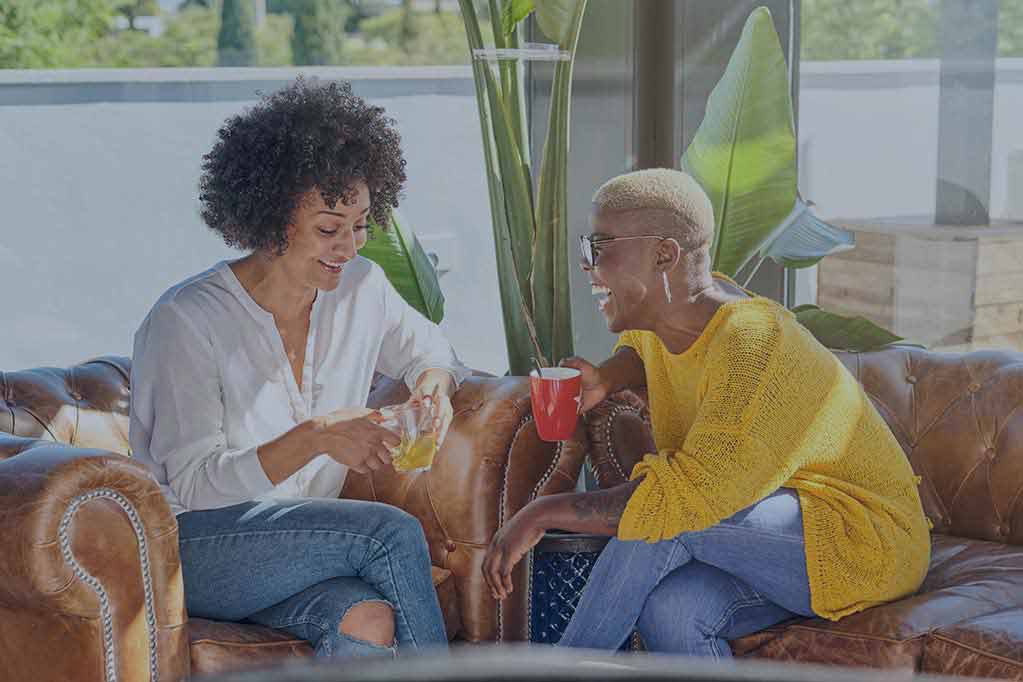 1cheerful-diverse-women-having-fun-on-sofa-at-home-2025-04-04-02-12-36-utc