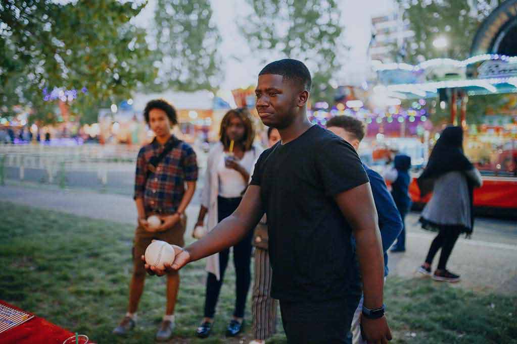 1group-of-friends-at-funfair-boy-holding-ball-loo-2025-04-04-22-04-12-utc