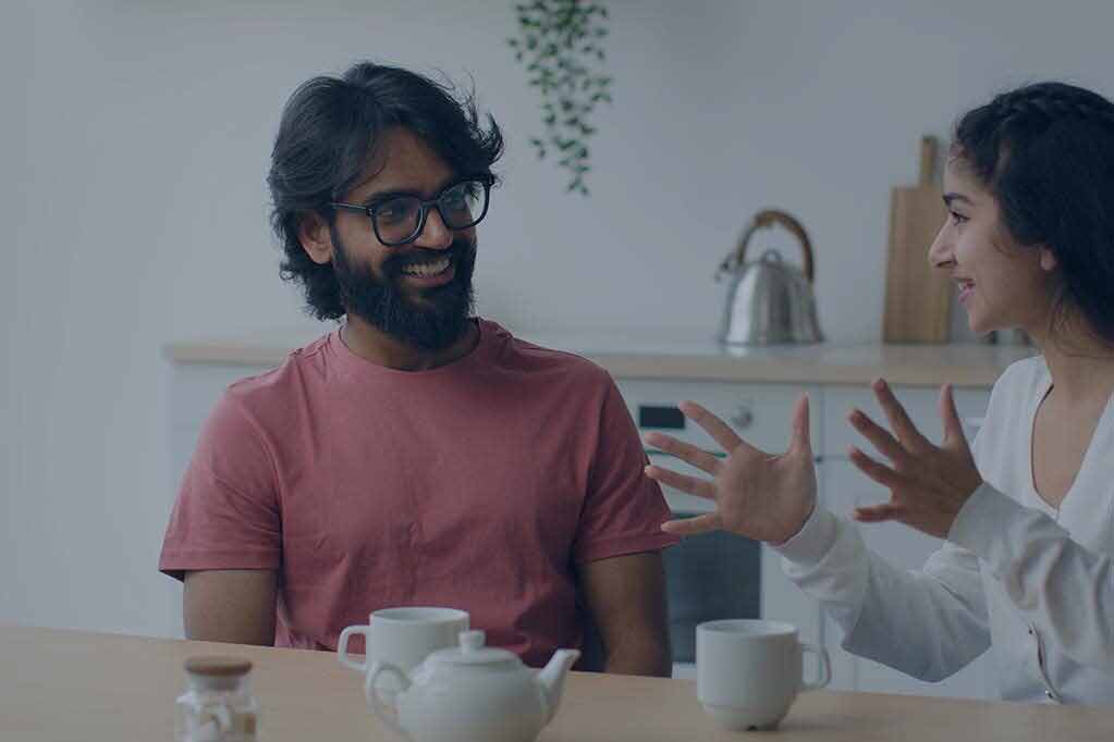 happy-multiracial-couple-drink-coffee-tea-in-home-2025-03-24-00-14-00-utc-e1756898926338